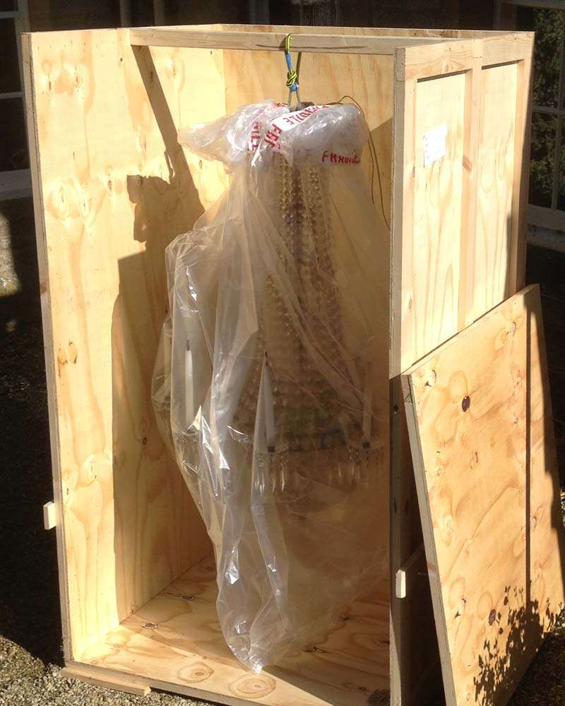 A chandelier wrapped and boxed for removal