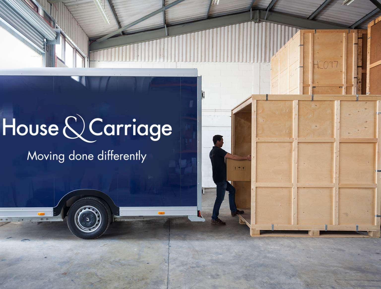 Man unpacking a removals van into storage